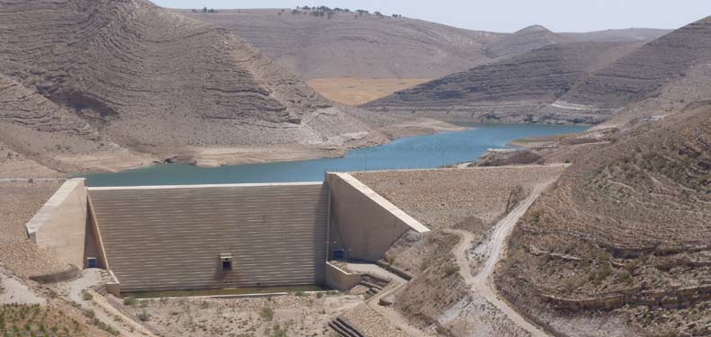 A dam and stored water in an arid landscape, from the SMART project brochure